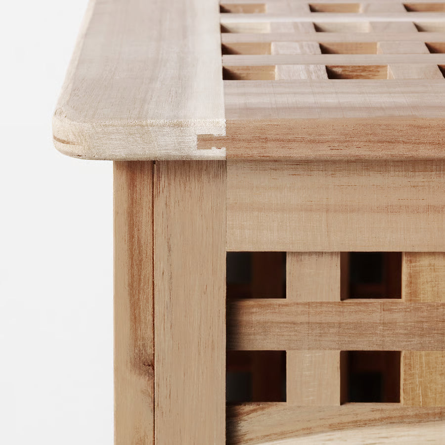 Close-up of a wooden bench with lattice design on a white background